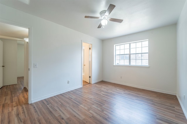 unfurnished bedroom featuring ceiling fan, wood-type flooring, and ensuite bathroom