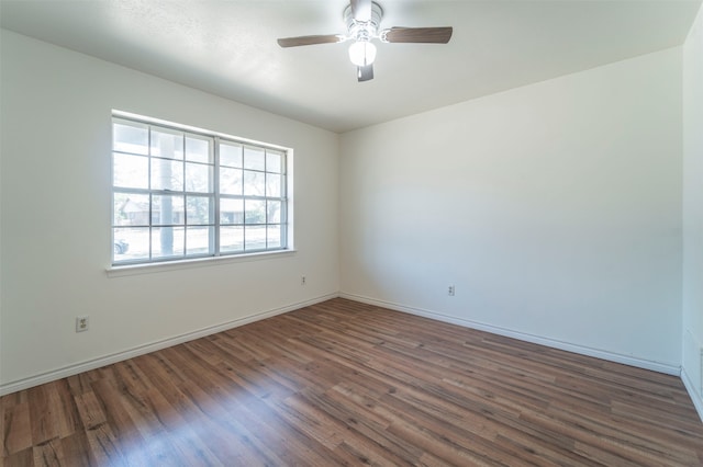 spare room with ceiling fan and dark hardwood / wood-style flooring