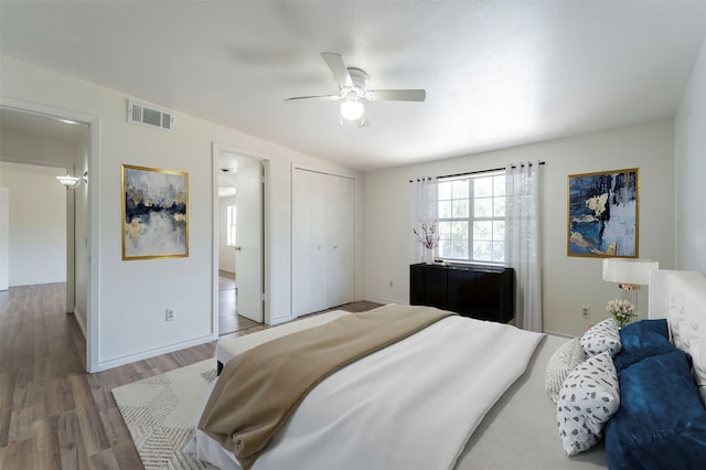 bedroom featuring hardwood / wood-style flooring, a closet, and ceiling fan