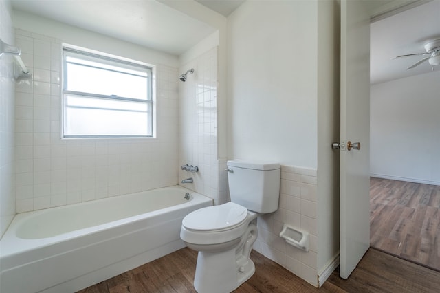 bathroom with ceiling fan, tiled shower / bath, toilet, and hardwood / wood-style floors