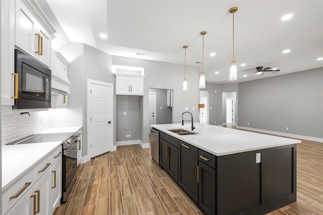 kitchen with white cabinets, ceiling fan, sink, tasteful backsplash, and black appliances