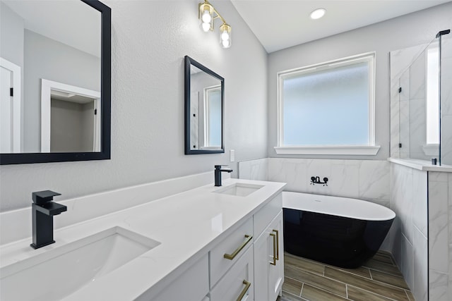 bathroom featuring tile walls, double vanity, and tile patterned flooring