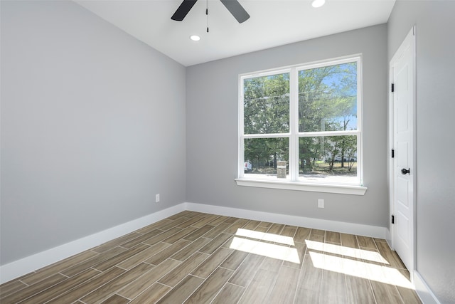 unfurnished room featuring plenty of natural light, hardwood / wood-style floors, and ceiling fan