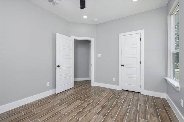 unfurnished bedroom with wood-type flooring, a closet, and ceiling fan