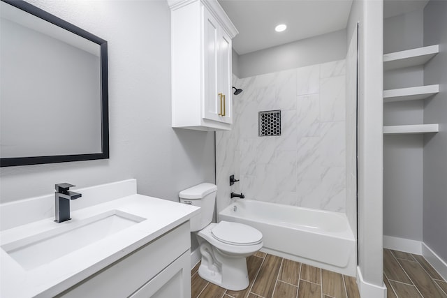 full bathroom featuring tiled shower / bath combo, vanity, and toilet