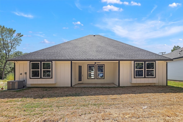 rear view of property featuring a lawn, a patio, and central AC unit