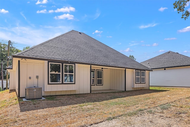 rear view of property with central AC