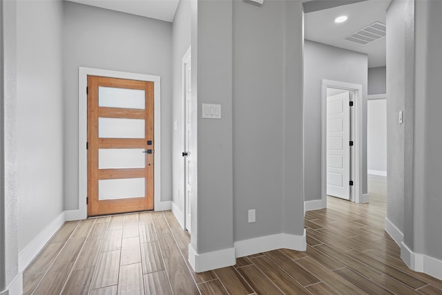 entryway with hardwood / wood-style flooring