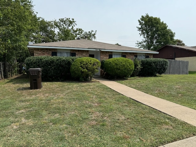 ranch-style home with a front lawn