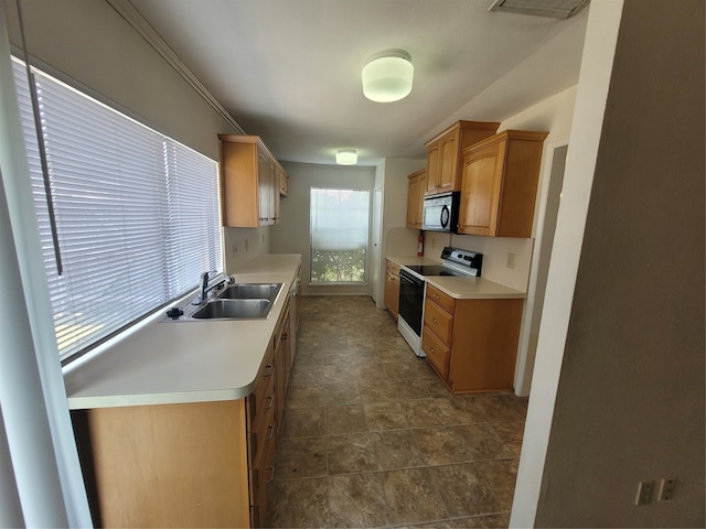 kitchen with white range with electric cooktop, sink, and dark tile patterned floors