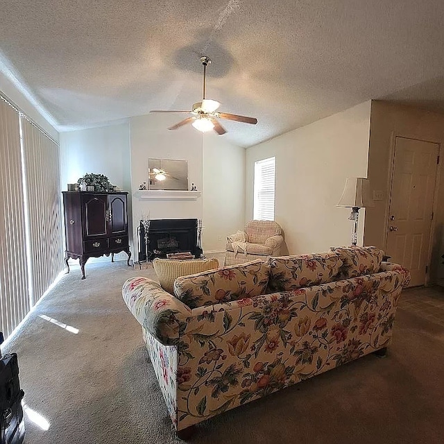 carpeted living room with a textured ceiling and ceiling fan