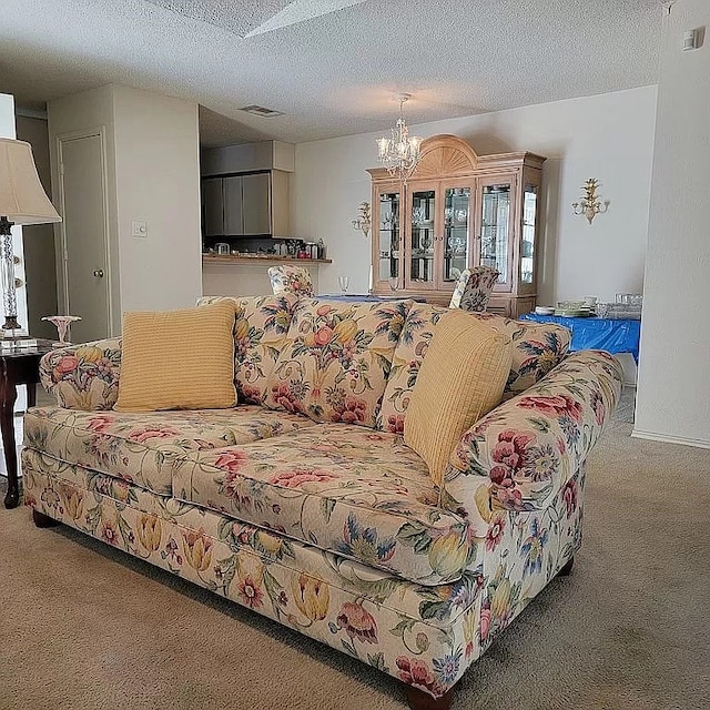 living room featuring a textured ceiling, carpet flooring, and a chandelier