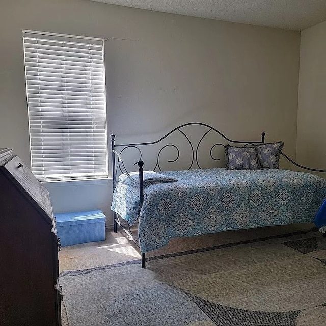 carpeted bedroom with a textured ceiling