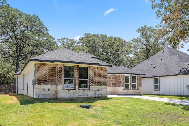 back of house with a patio, a yard, and a garage