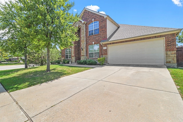 view of front facade with a front yard and a garage