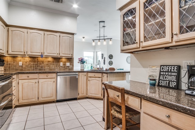 kitchen featuring pendant lighting, crown molding, light tile patterned flooring, appliances with stainless steel finishes, and sink