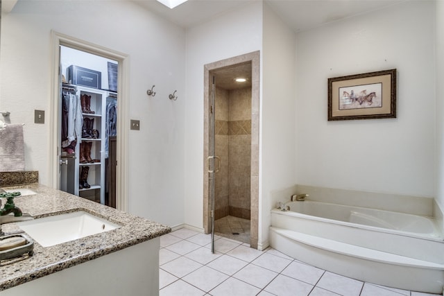 bathroom featuring tile patterned floors, vanity, and plus walk in shower