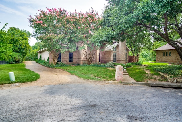 obstructed view of property featuring a front yard