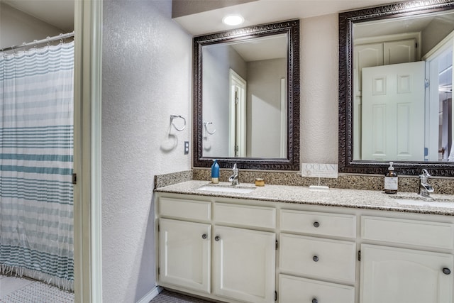 bathroom featuring dual bowl vanity