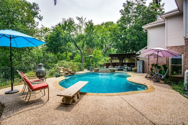 view of pool featuring a pergola, a patio, a diving board, and an in ground hot tub