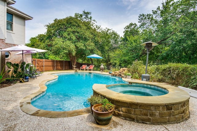 view of pool featuring an in ground hot tub and a patio area