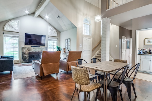 dining area with ornate columns, high vaulted ceiling, a fireplace, brick wall, and beamed ceiling