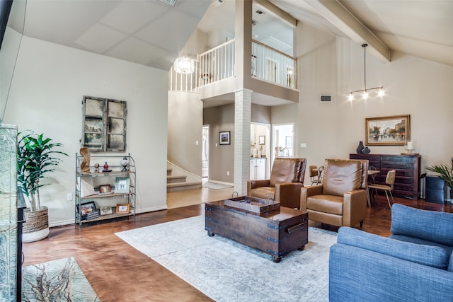 living room featuring decorative columns, high vaulted ceiling, hardwood / wood-style flooring, and beamed ceiling