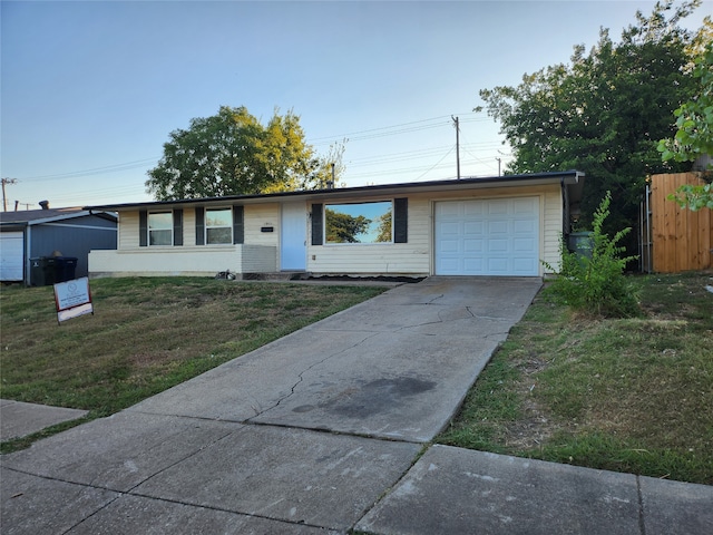 ranch-style home with a garage and a front yard