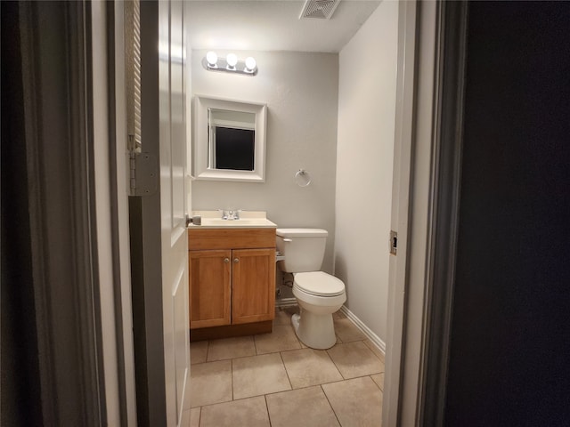 bathroom featuring tile patterned floors, toilet, and vanity