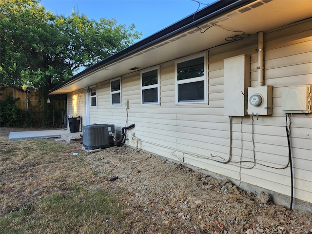 view of side of home with central air condition unit