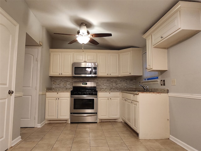 kitchen featuring light tile patterned floors, appliances with stainless steel finishes, stone countertops, ceiling fan, and tasteful backsplash