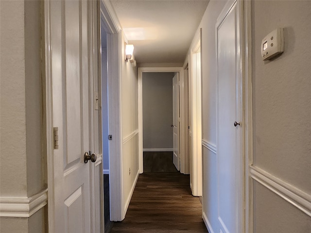 corridor with dark wood-type flooring