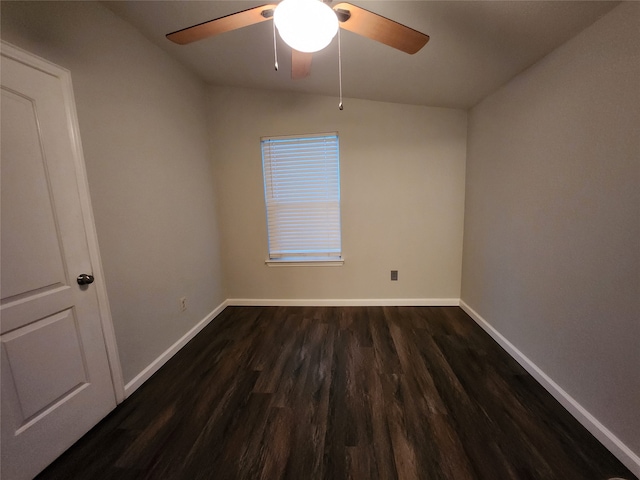 spare room featuring ceiling fan, dark hardwood / wood-style floors, and vaulted ceiling