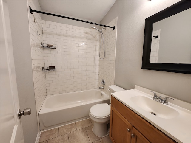 full bathroom featuring vanity, tiled shower / bath, tile patterned floors, and toilet