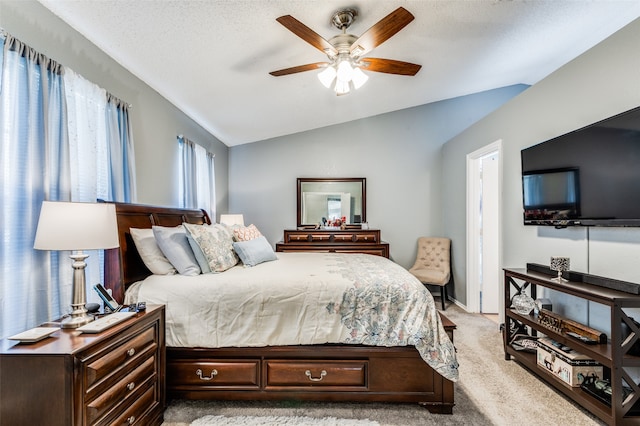 carpeted bedroom with ceiling fan, lofted ceiling, and multiple windows