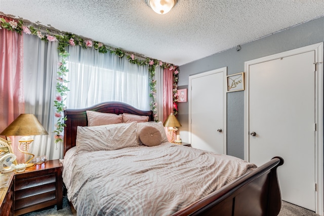 carpeted bedroom with a textured ceiling