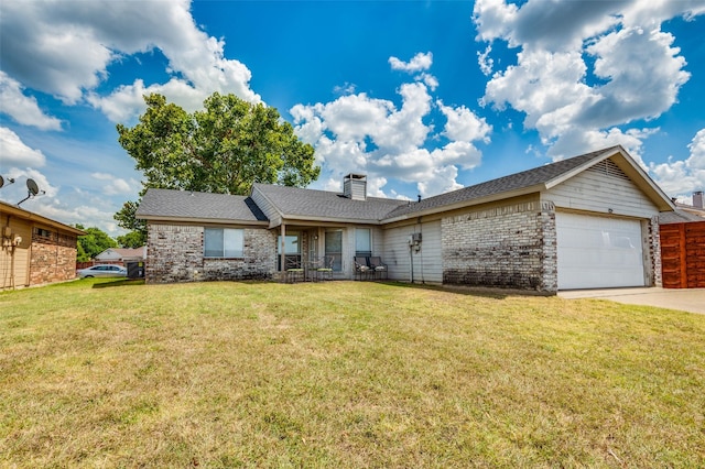 single story home with brick siding, a chimney, concrete driveway, an attached garage, and a front yard