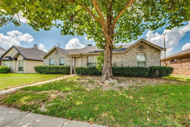 ranch-style home with brick siding and a front lawn