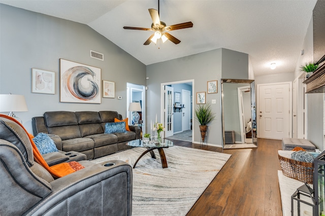 living room featuring ceiling fan, vaulted ceiling, and hardwood / wood-style flooring