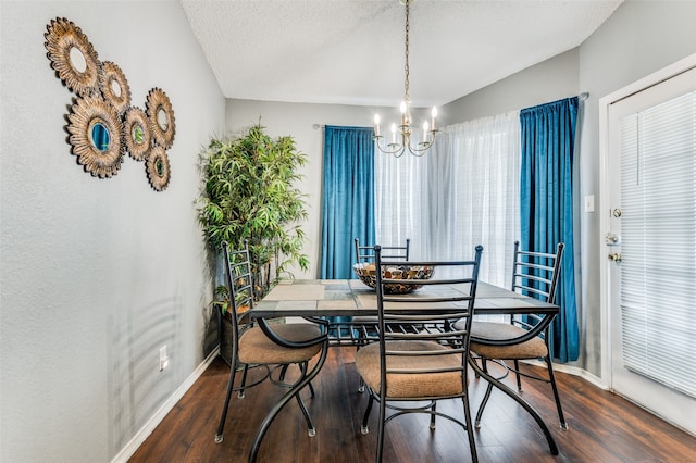 dining room featuring wood-type flooring, a chandelier, and a textured ceiling