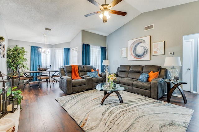 living room featuring a textured ceiling, dark hardwood / wood-style flooring, lofted ceiling, and ceiling fan with notable chandelier