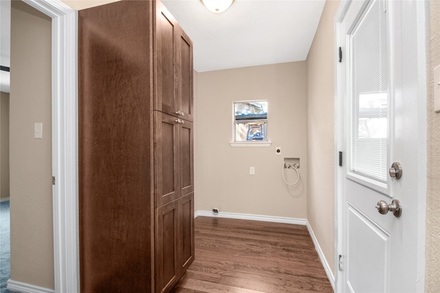 laundry room with cabinets, hardwood / wood-style floors, and electric dryer hookup