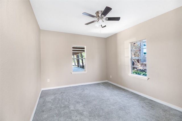 empty room featuring carpet floors, a wealth of natural light, and ceiling fan