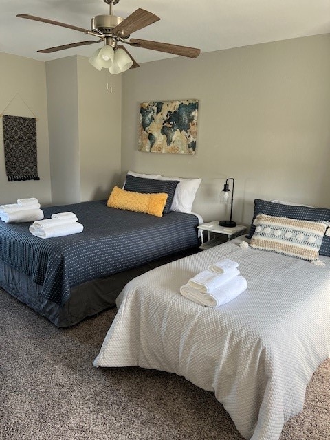 bedroom with ceiling fan and carpet