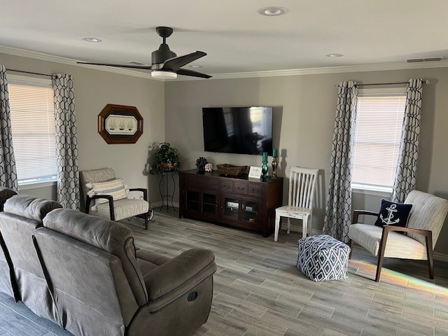 living room featuring ceiling fan, crown molding, and hardwood / wood-style floors