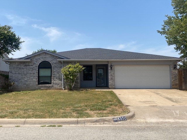 single story home featuring a front lawn and a garage