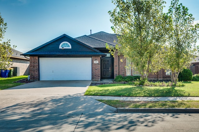 view of front of house with a front lawn and a garage