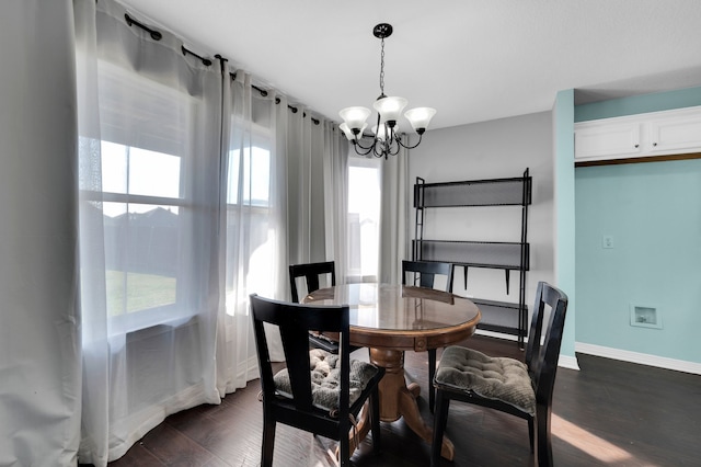 dining area with a notable chandelier and dark hardwood / wood-style floors