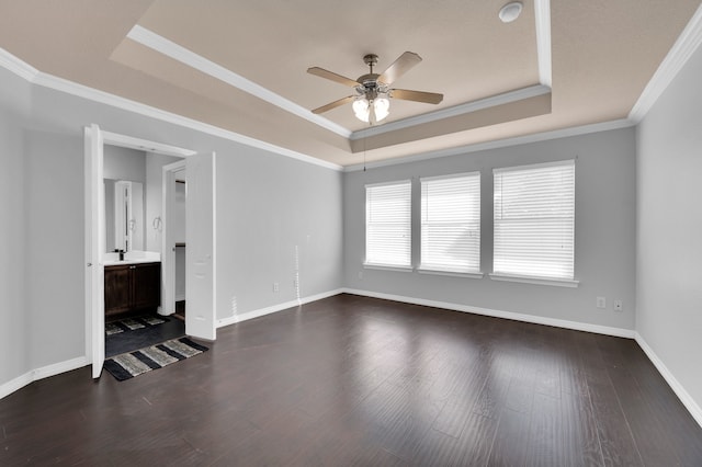 unfurnished room featuring ceiling fan, crown molding, hardwood / wood-style floors, and a tray ceiling