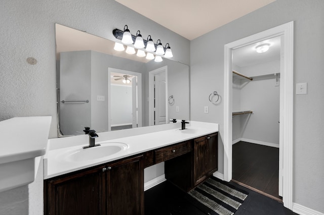 bathroom with hardwood / wood-style floors, dual bowl vanity, and ceiling fan